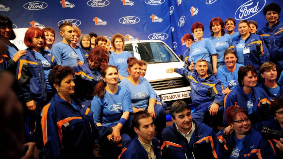 Ford workers in Romania pose with Transit van