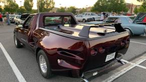 an 80s car turned into a pickup truck in a parking lot