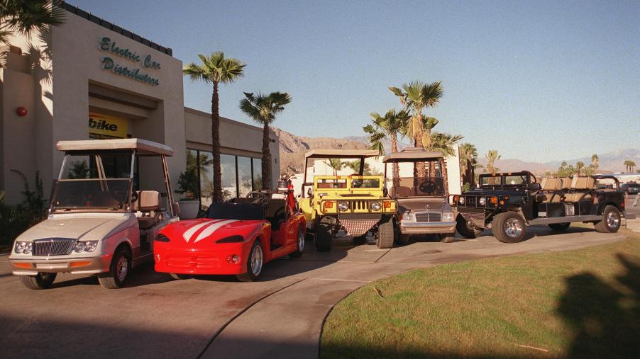A selection of custom golf carts are on display at a dealership