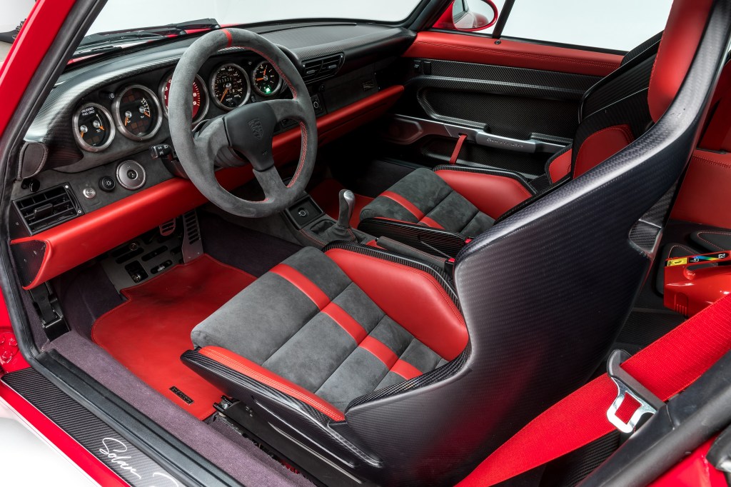 Black-and-red Gunther Werks 400R interior, with carbon-fiber bucket seats with red bolstering