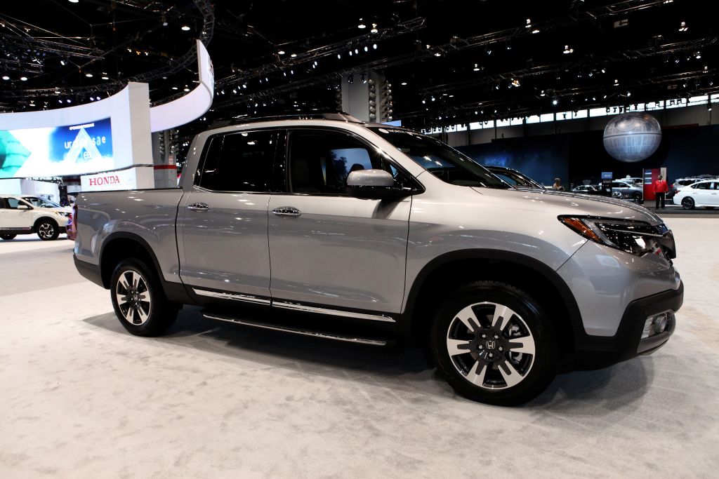 A silver 2020 Honda Ridgeline on display at an auto show