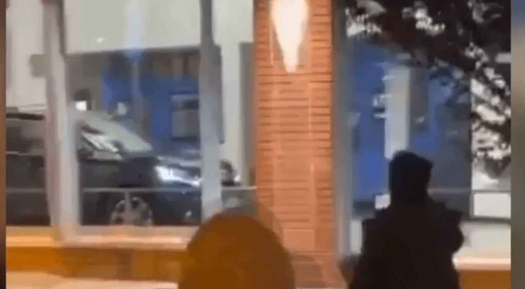 Looking into the Oakland Honda delership as a car is being stolen during Floyd riots