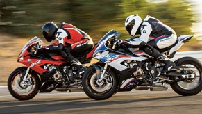 2 2020 BMW S1000RRs, one red and one red-white-and-blue, race side-by-side