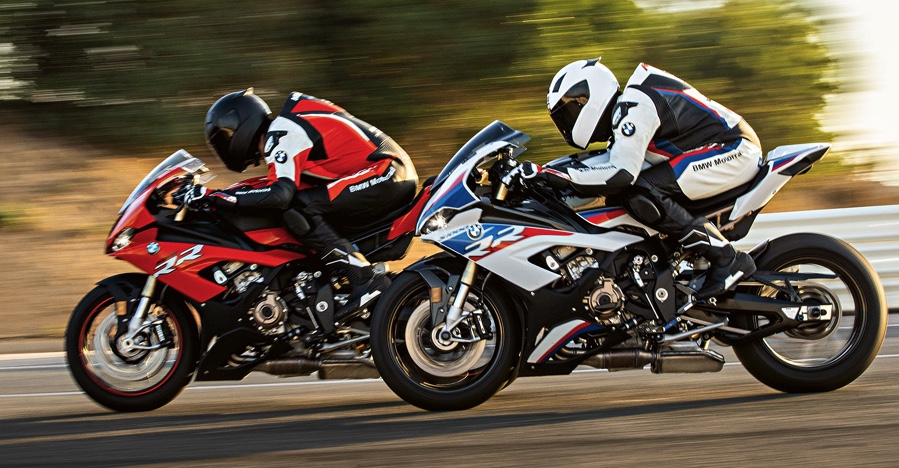 2 2020 BMW S1000RRs, one red and one red-white-and-blue, race side-by-side