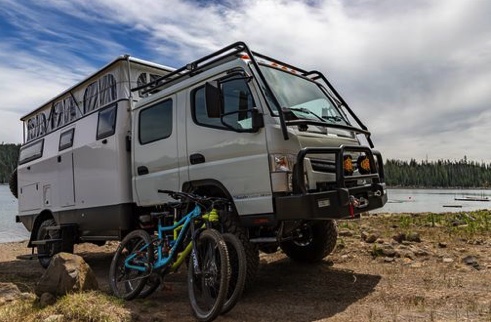EarthCruiser dual cab RV with the family bikes leaning up against the cab