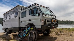 EarthCruiser dual cab RV with the family bikes leaning up against the cab
