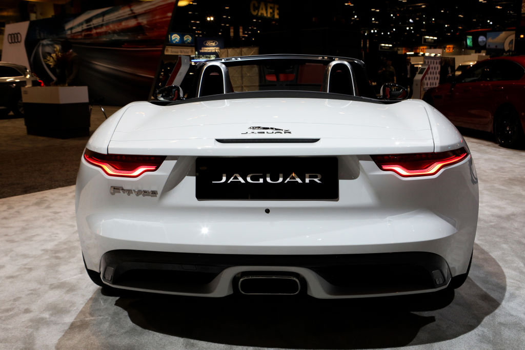 A white 2020 Jaguar F-Type on display at an auto show