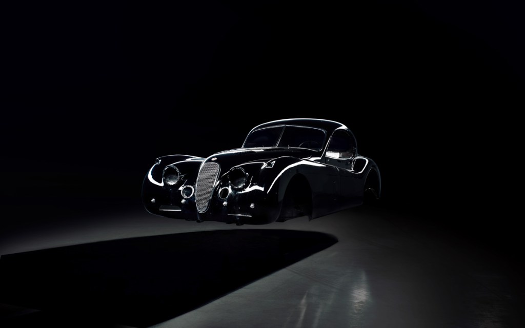 The shell of classic, black, Jaguar XK 120 that is being converted to electric power