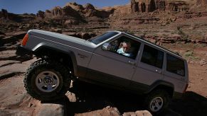 Jeep off-roading over rocks in Moab, Utah