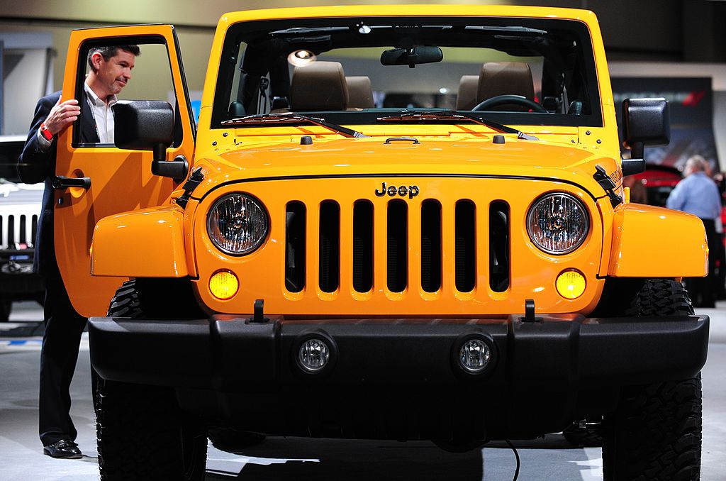the front grille design of a yellow Jeep Wrangler 
