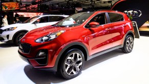 A red Kia Sportage on display at an auto show