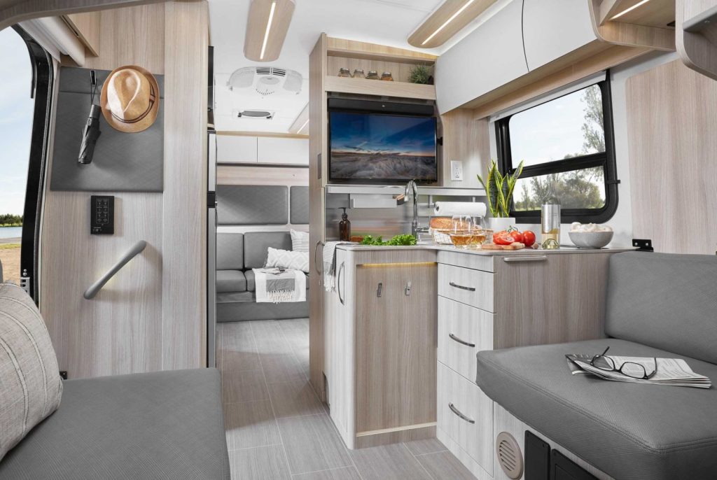 A view of the kitchen, the counters, and seating within the RV
