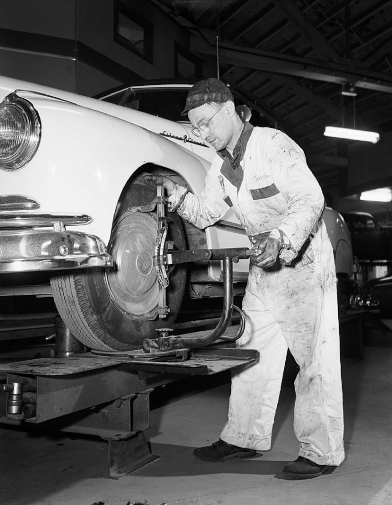 Mechanic performing a wheel alignment