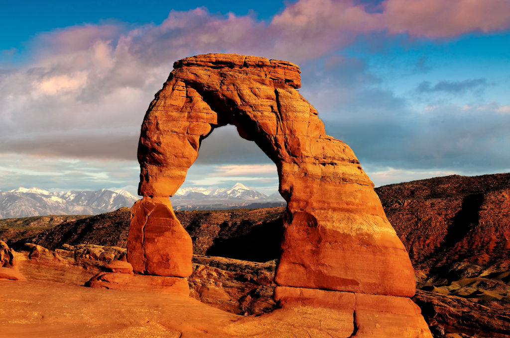a delkicate arch as the sun rises in Moab
