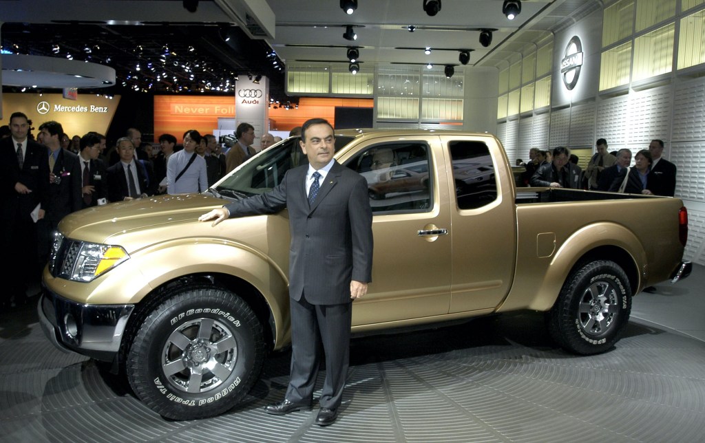Nissan President and CEO Carlos Ghosn poses with the new 2005 Frontier pickup truck after a news conference at the North American International Auto Show