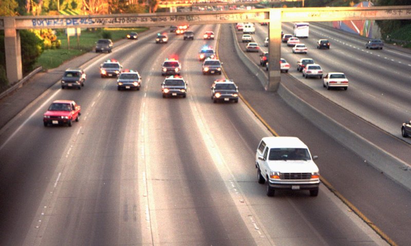 The white Ford Bronco in the OJ Simpson police chase driving down an LA highway in traffic.