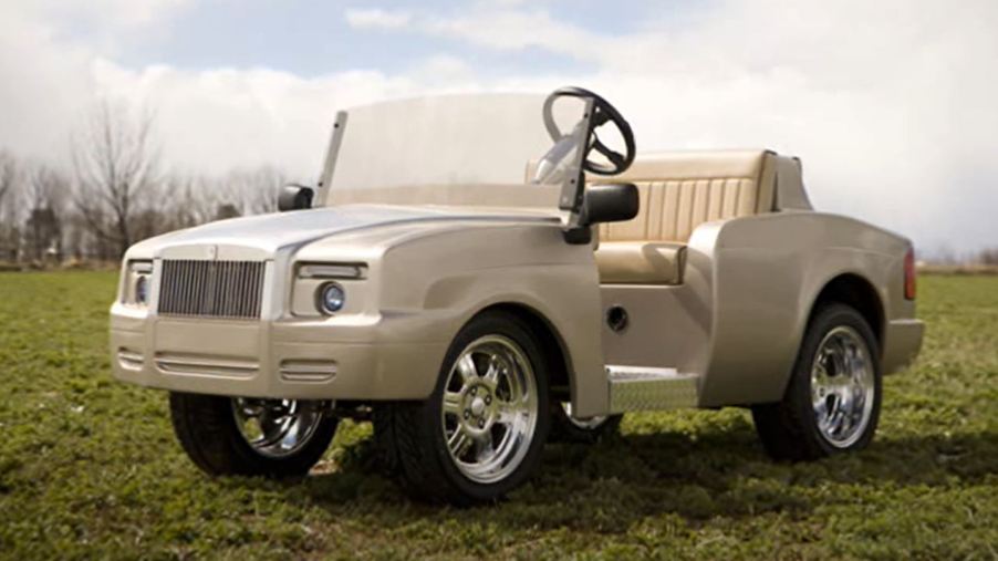 A custom gold colored Rolls-Royce Shadow golf cart