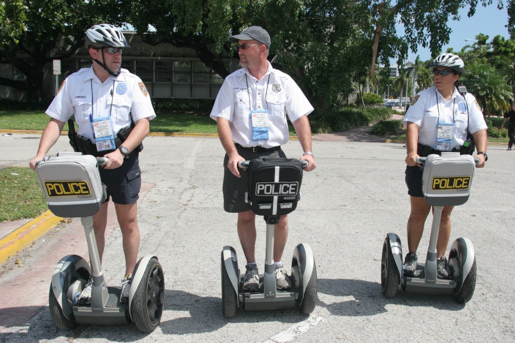 Three police officer ride Segways scooters as part of training.