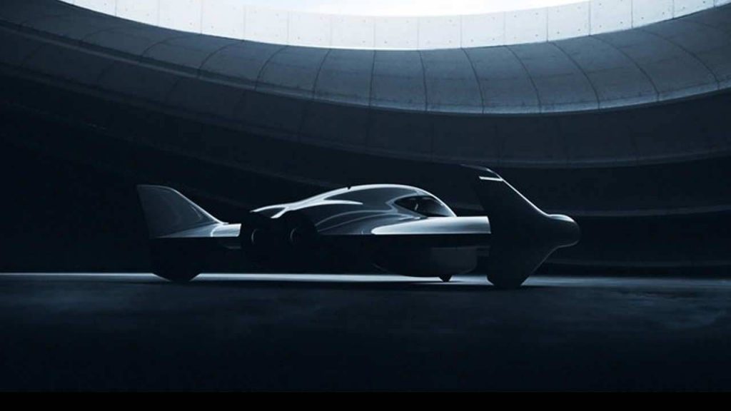 flying sports car sitting in a hangar in a dark setting