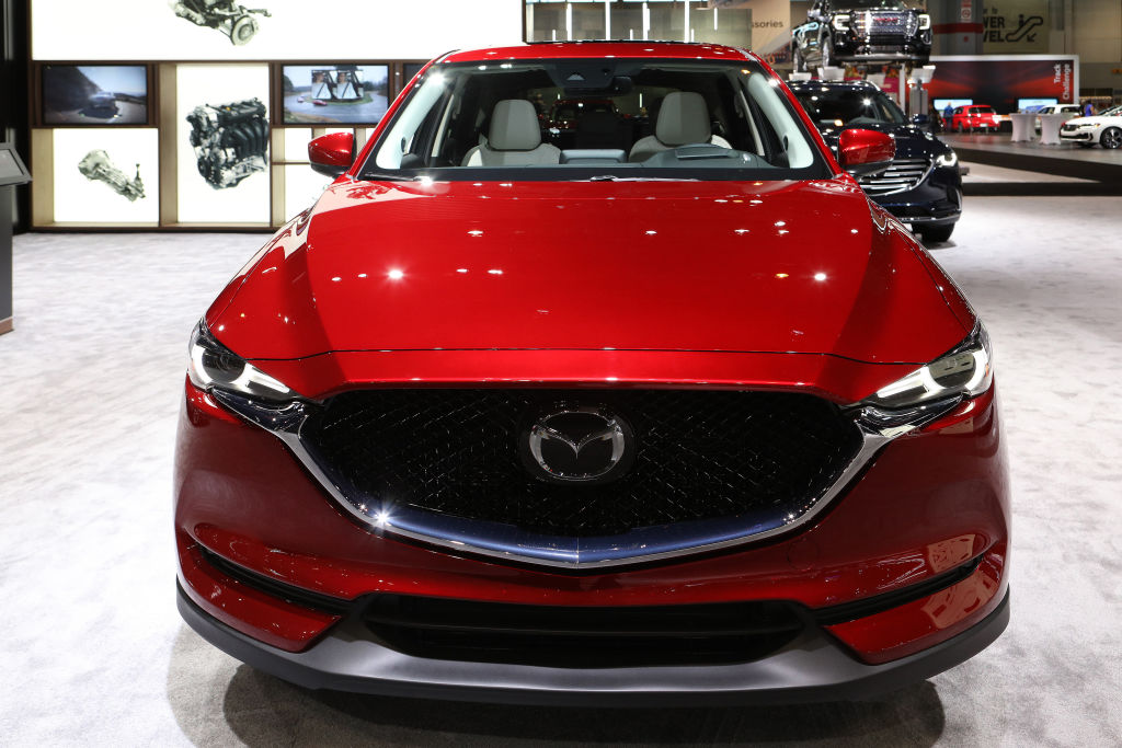 A red Mazda CX-5 on display at an auto show