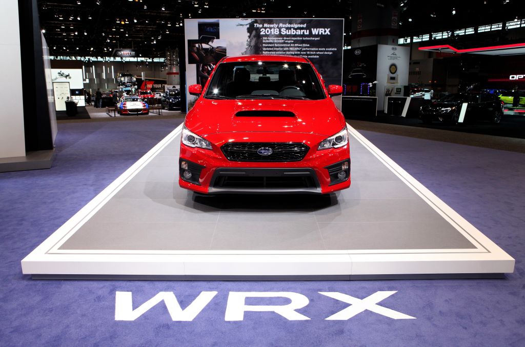 A red Subaru WRX on display at an auto show