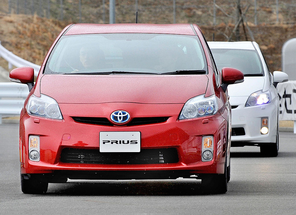 A Toyota Prius driving down the road