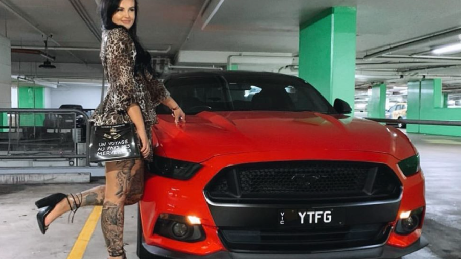 Supercar driver Renee Gracie poses with red Mustang