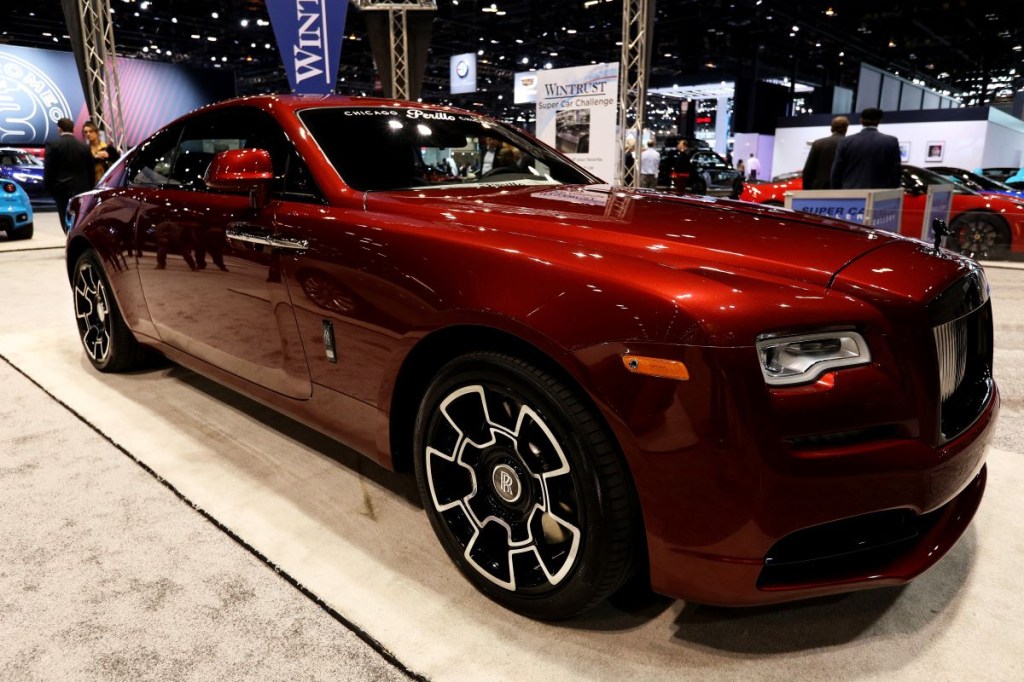 A burgundy Rolls-Royce Wraith sitting on display