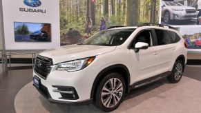 A white Subaru Ascent on display at an auto show