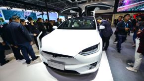 People watch Tesla Model X at Tesla booth on day three of the 2nd China International Import Expo (CIIE) at the National Exhibition and Convention Center