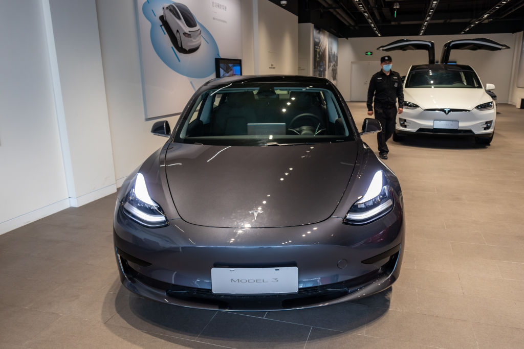 A Tesla Model 3 car and a Tesla Model X vehicle are seen at the first Tesla Center in Shanghai
