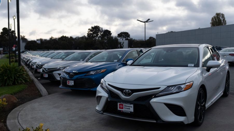 A can dealership lot with Toyota Camrys for sale