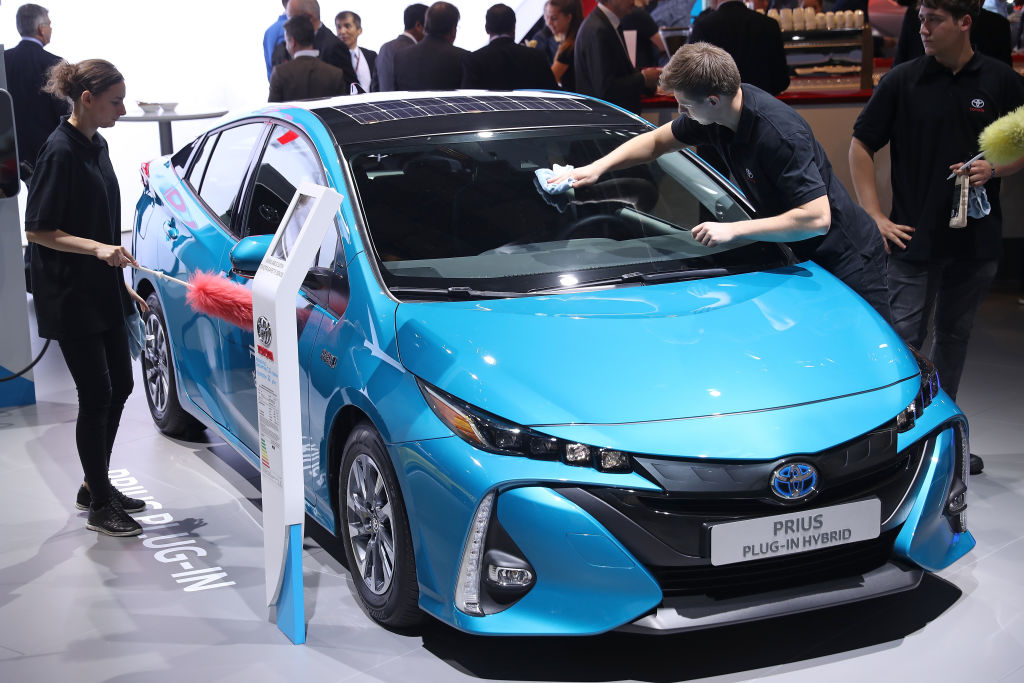 Workers prepare a Toyota Prius plug-in hybrid at the 2017 Frankfurt Auto Show on September 12, 2017