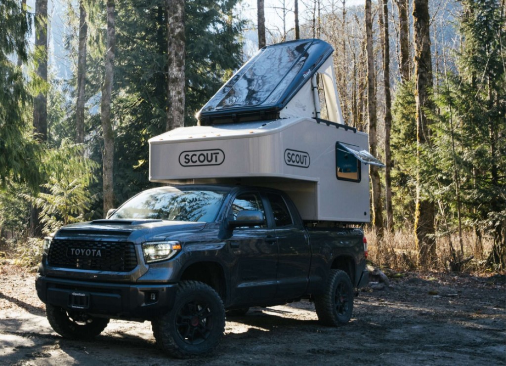 Green Toyota Tundra with Toyota Tundra with Scout Campers Olympic truck camper mounted in the bed