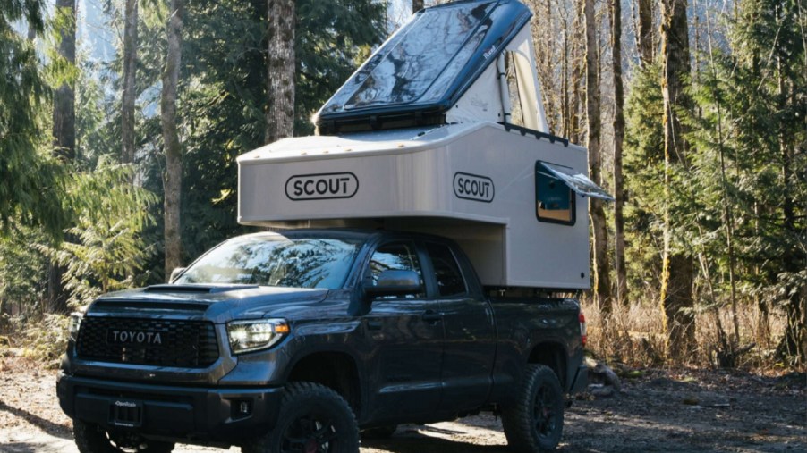 Green Toyota Tundra with Toyota Tundra with Scout Campers Olympic truck camper mounted in the bed