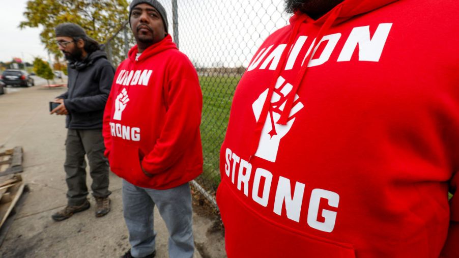 two UAW worker in red sweatshirts outside of GM