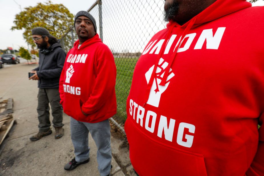 two UAW worker in red sweatshirts outside of GM