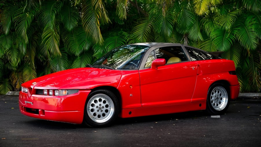 Red 1990 Alfa Romeo SZ in front of some green trees