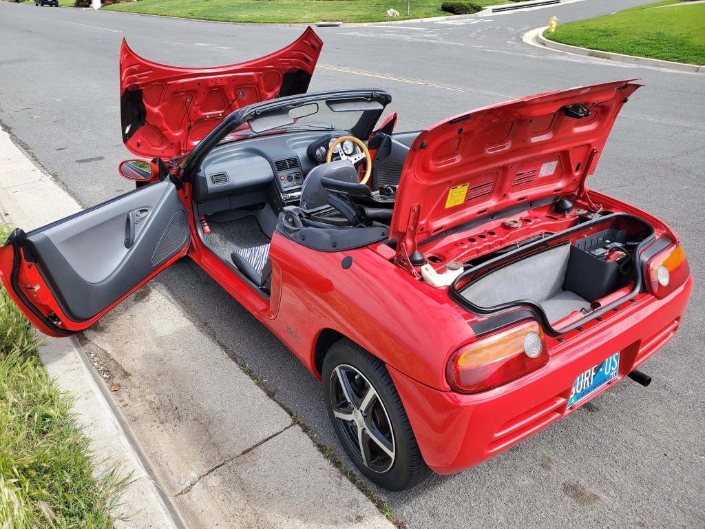 Rear view of a red 1991 Honda Beat, with all doors and trunk lids open