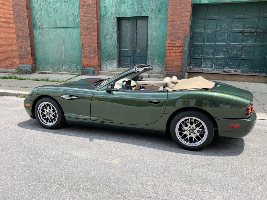 The side view of a green 2001 Panoz Esperante convertible