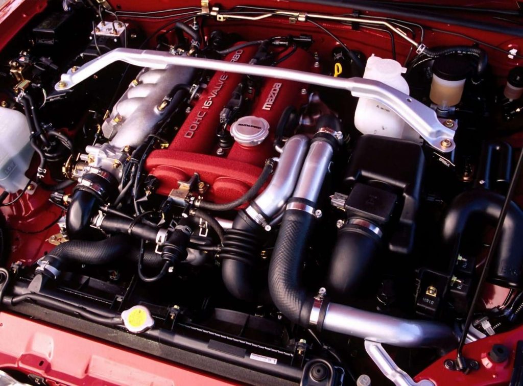 The 2004 Mazdaspeed Miata's engine bay, showing the strut-tower brace and red engine cover