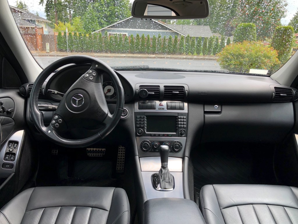 The black-and-silver interior of a 2005 Mercedes-Benz C55 AMG
