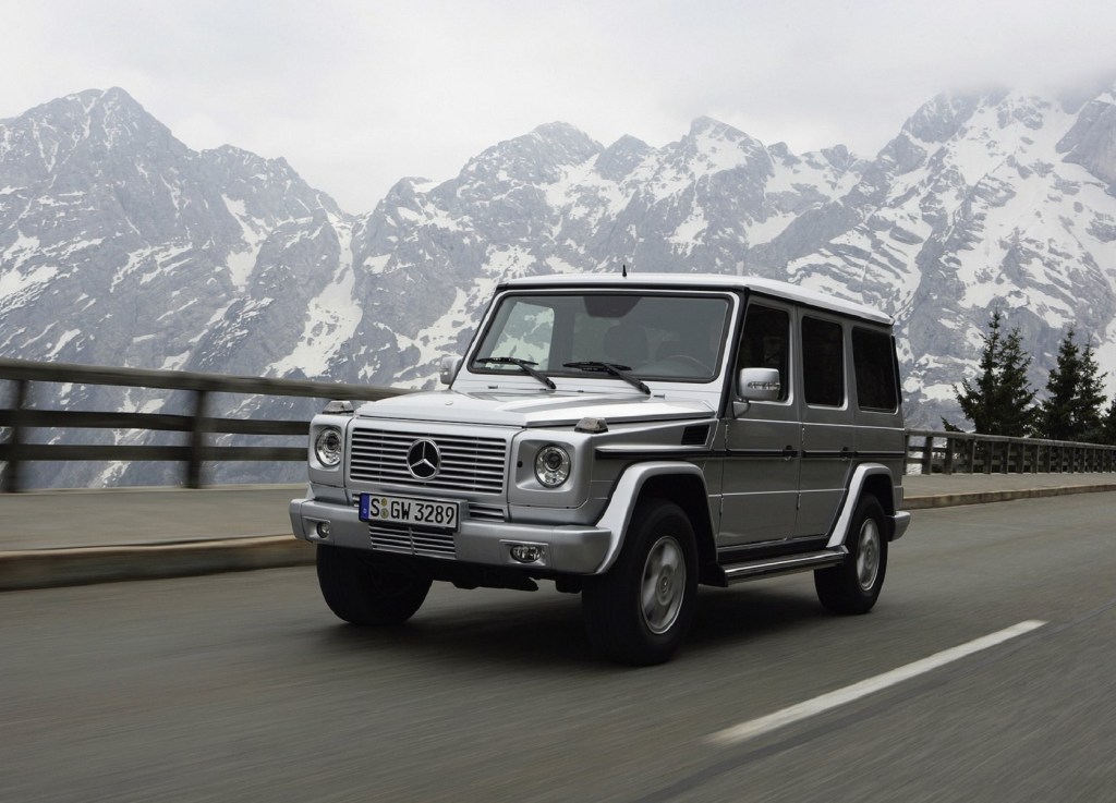 A silver 2007 Mercedes G550 G-Wagon drives on a mountain road