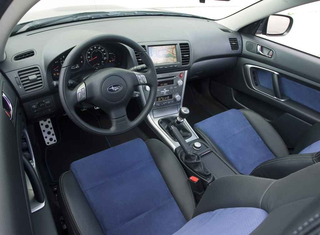 Interior shot of the 2007 Subaru Legacy 2.5GT Spec B, showing the 6-speed manual, blue-and-leather-trimmed seats, and navigation