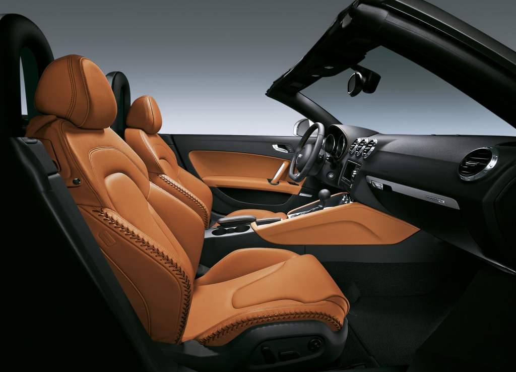 The tan-leather-with-baseball-stitching interior of a 2008 Audi TT Roadster 3.2 Quattro