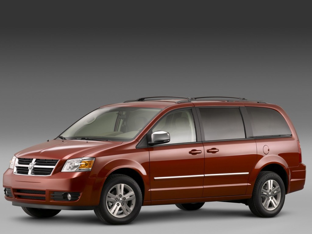 A red 2008 Dodge Grand Caravan against a gray background.