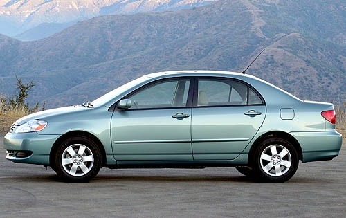 a 2008 Toyota Corolla side view with a mountainous backdrop
