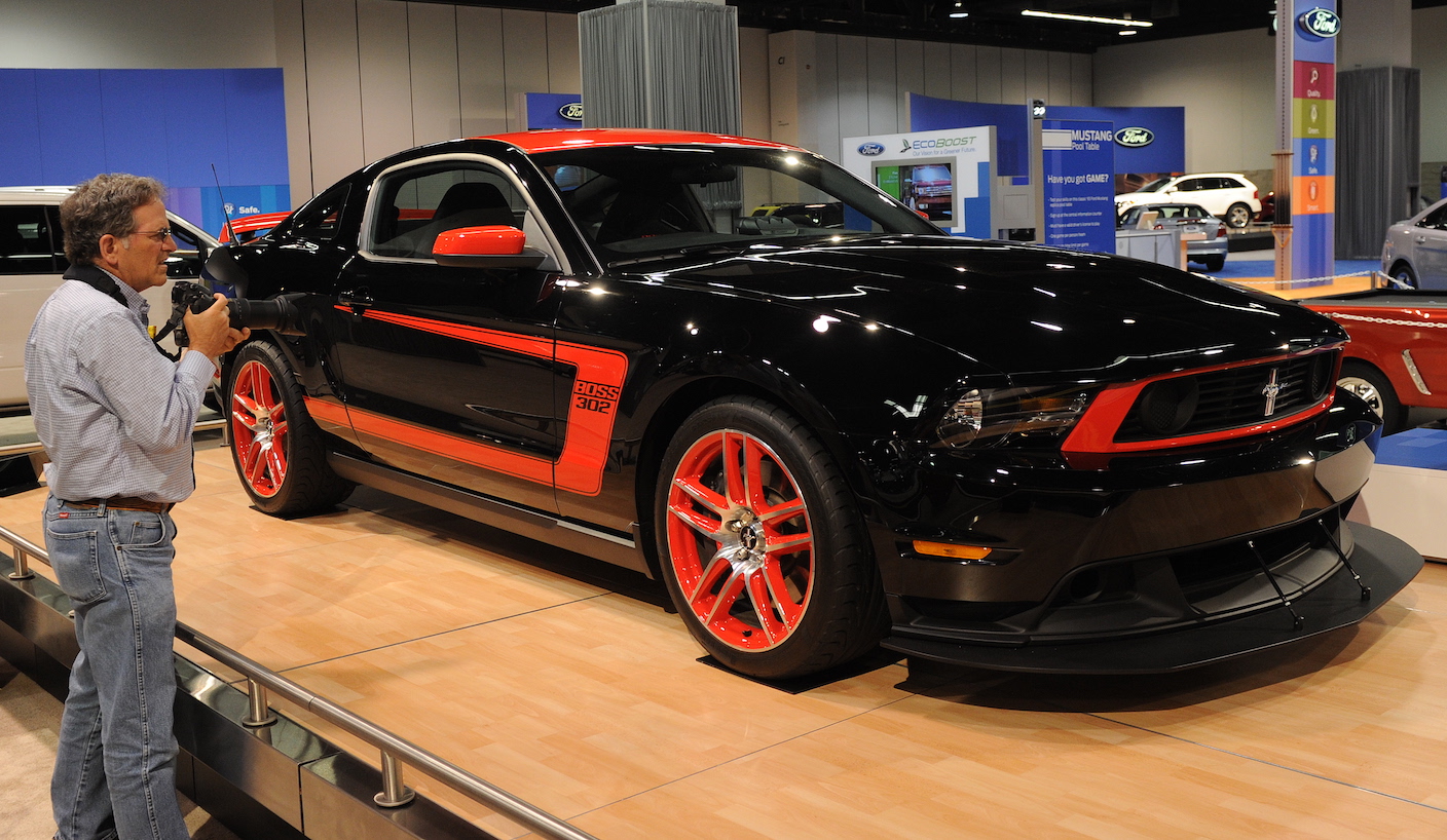 A man looks at the new black 2010 Mustang on display at the Orange County Auto Show