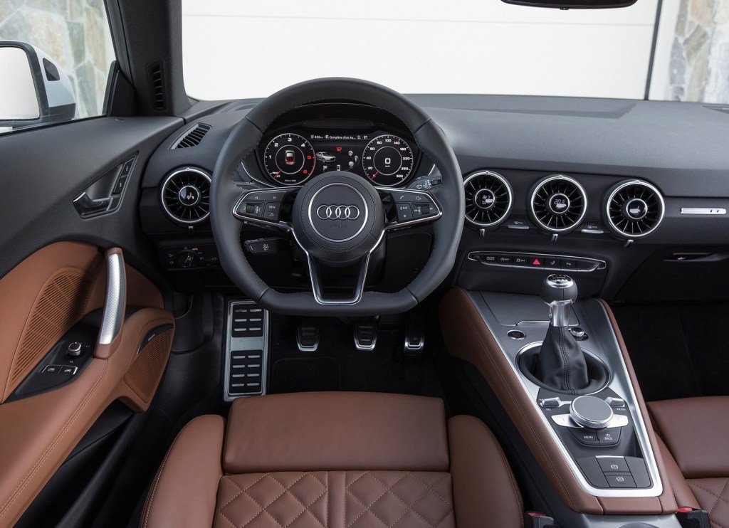 An interior shot of the 2015 Audi TT Coupe's interior, showing brown leather and a black dashboard
