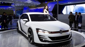 Models pose next to a 2015 Volkswagen GTI at the Seoul Motor Show